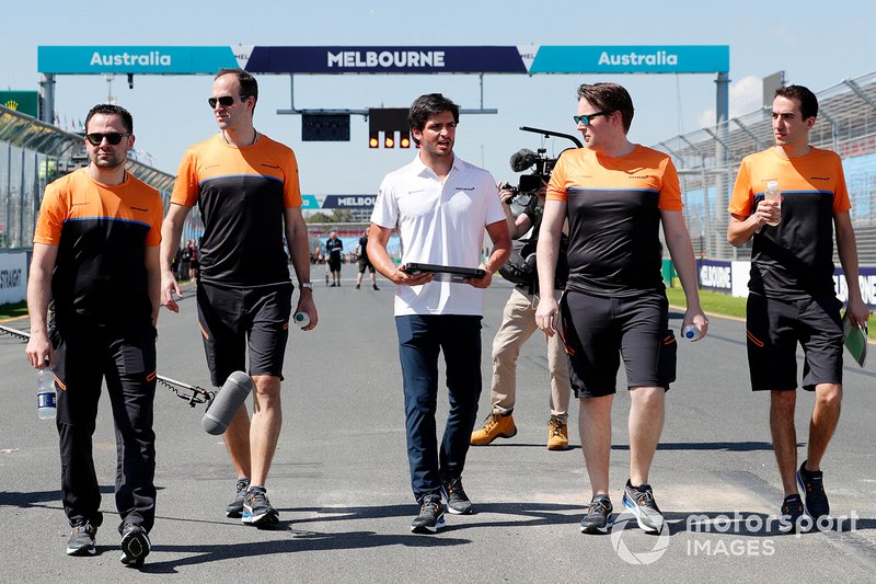 Carlos Sainz Jr., McLaren walks the track with members of the team