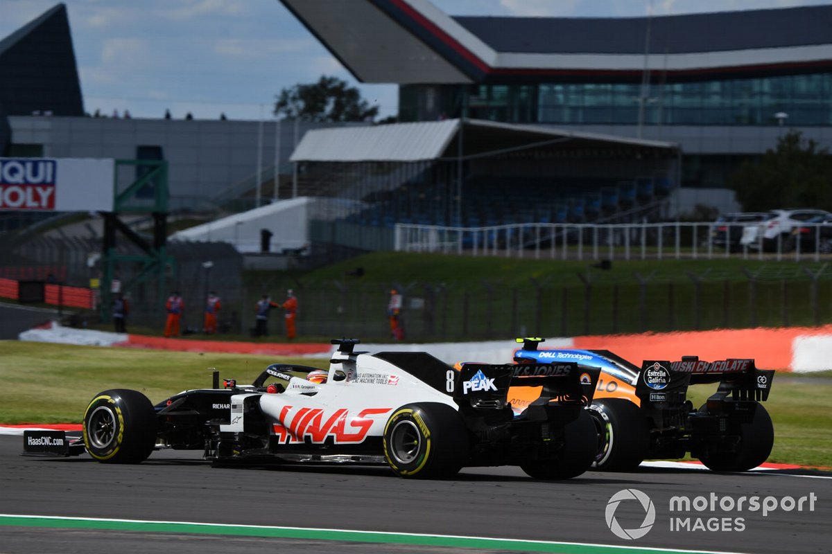 Romain Grosjean, Haas VF-20, battles with Lando Norris, McLaren MCL35