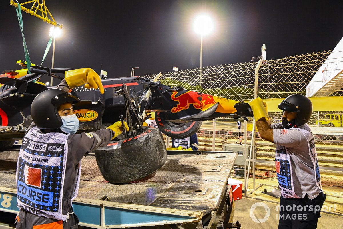 Marshals work to load Alexander Albon's Red Bull Racing RB16 onto a truck