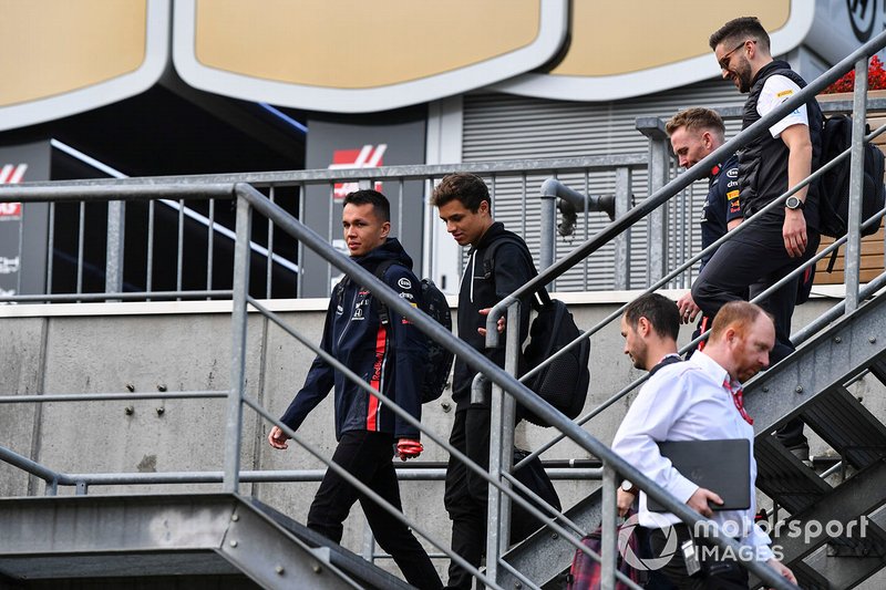 Alex Albon, Red Bull, and Lando Norris, McLaren, arrive at the circuit