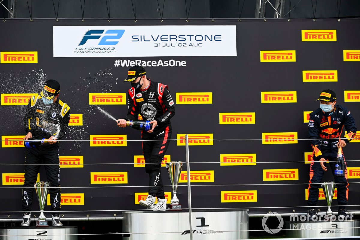 Guanyu Zhou, UNI-Virtuosi, 2nd position, Nikita Mazepin, Hitech Grand Prix, 1st position, and Yuki Tsunoda, Carlin, 3rd position, celebrate with Champagne on the podium