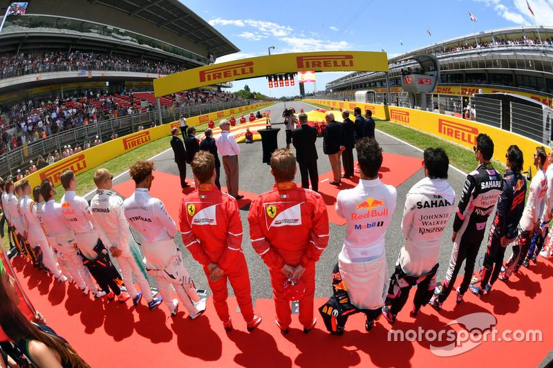 Drivers observe the national anthem