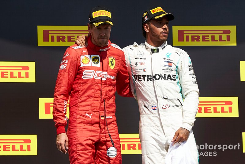 Sebastian Vettel, Ferrari, 2nd position, with Lewis Hamilton, Mercedes AMG F1, 1st position, on the podium