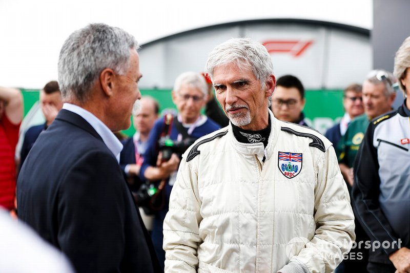 Damon Hill talks to Chase Carey, Chairman, Formula 1, after driving the Lotus 49 driven to the 1968 title by his father Graham Hill