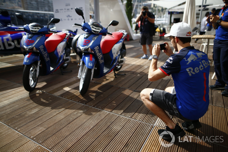 Pierre Gasly, Toro Rosso, takes a picture of Honda motorcycles
