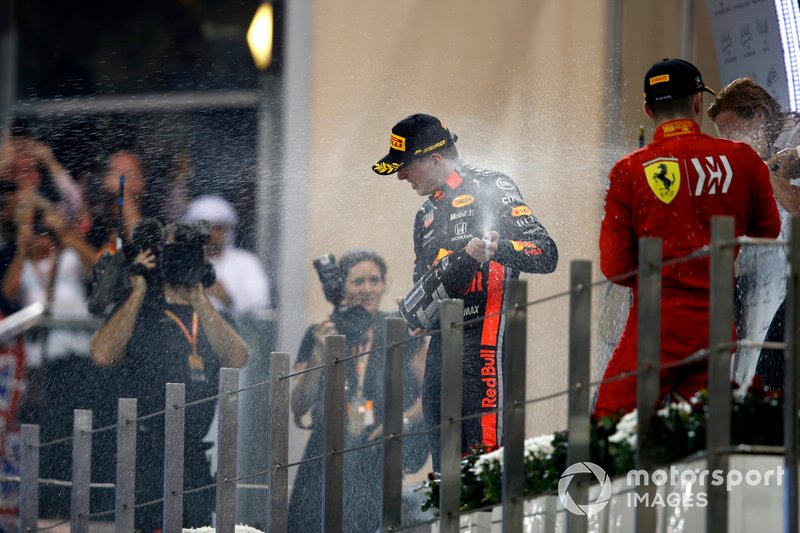Max Verstappen, Red Bull Racing, 2nd position, Lewis Hamilton, Mercedes AMG F1, 1st position, and Charles Leclerc, Ferrari, 3rd position, spray Champagne on the podium