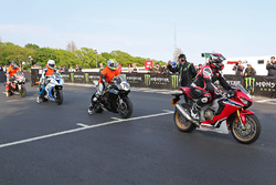 Isle of Man TT Rider Liaison officer Richard Milky Quayle gets proceedings underway by taking the Newcomers on their speed-controlled lap of the Mountain Course