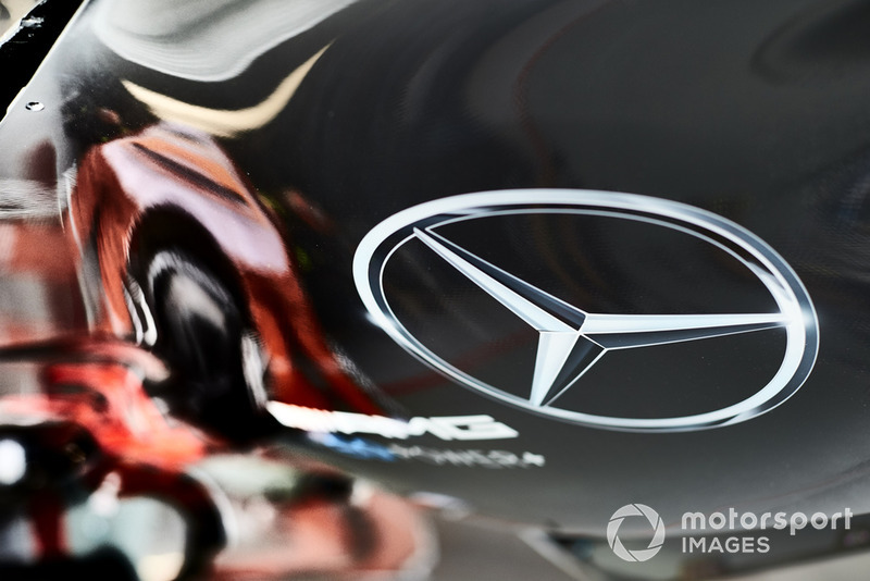 A Mercedes logo on an engine cover