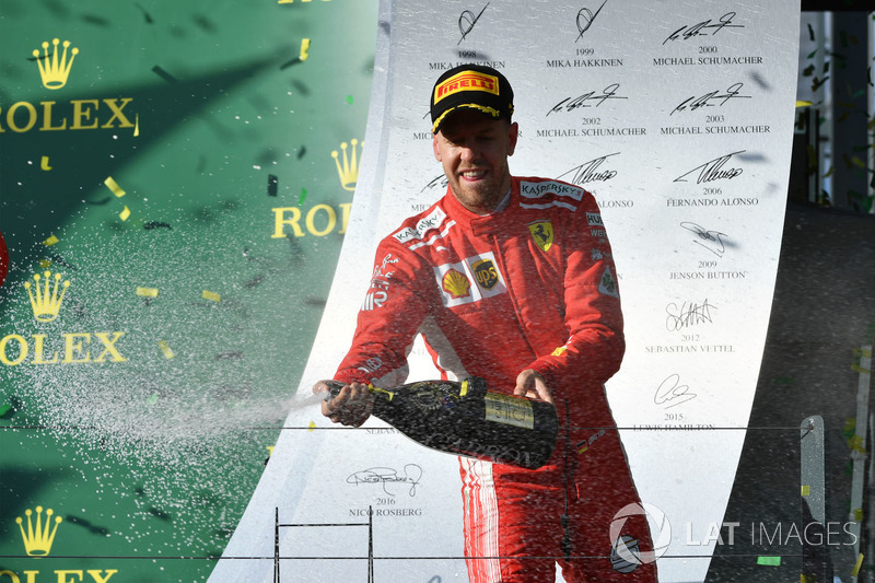 Race winner Sebastian Vettel, Ferrari celebrates on the podium with the champagne