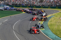 Sebastian Vettel, Ferrari SF70H, leads Valtteri Bottas, Mercedes AMG F1 W08, Kimi Raikkonen, Ferrari SF70H, Max Verstappen, Red Bull Racing RB13, and the remainder of the field through the first corner