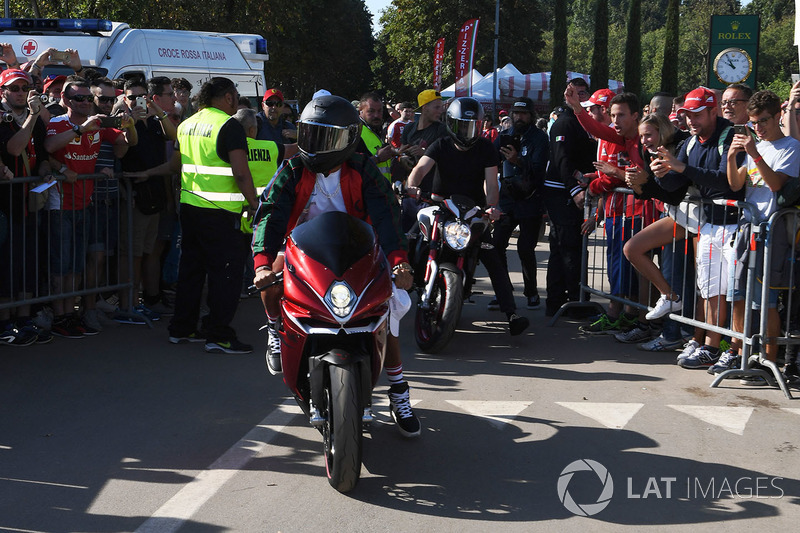 Lewis Hamilton, Mercedes AMG F1 arrives at the track on his motorbike