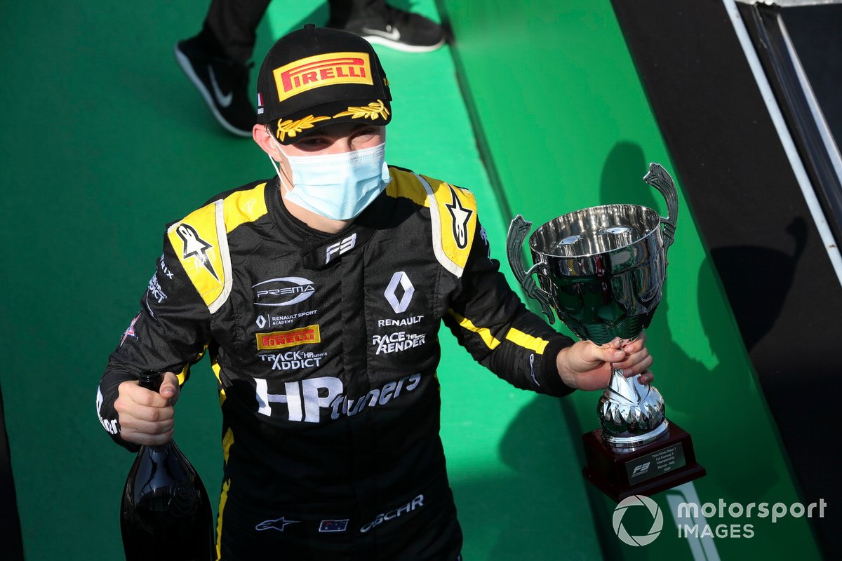 Oscar Piastri, Prema Racing celebrates on the podium with the champagne and the trophy