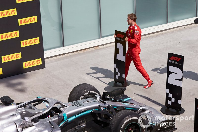 Sebastian Vettel, Ferrari, 2nd position, switches the position boards in protest of a penalty that cost him victory