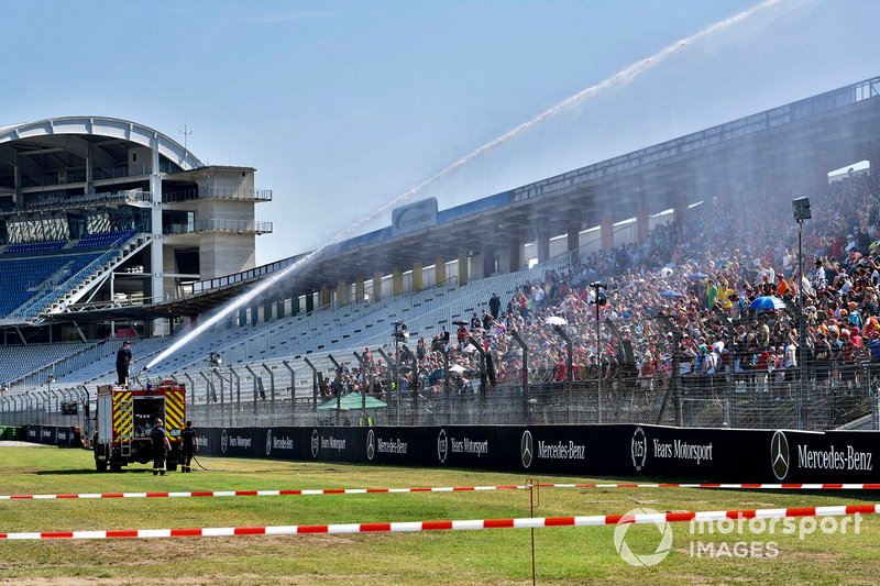 Fans being sprayed with water from a fire engine