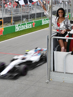 Winnnie Harlow, waves the chequered flag