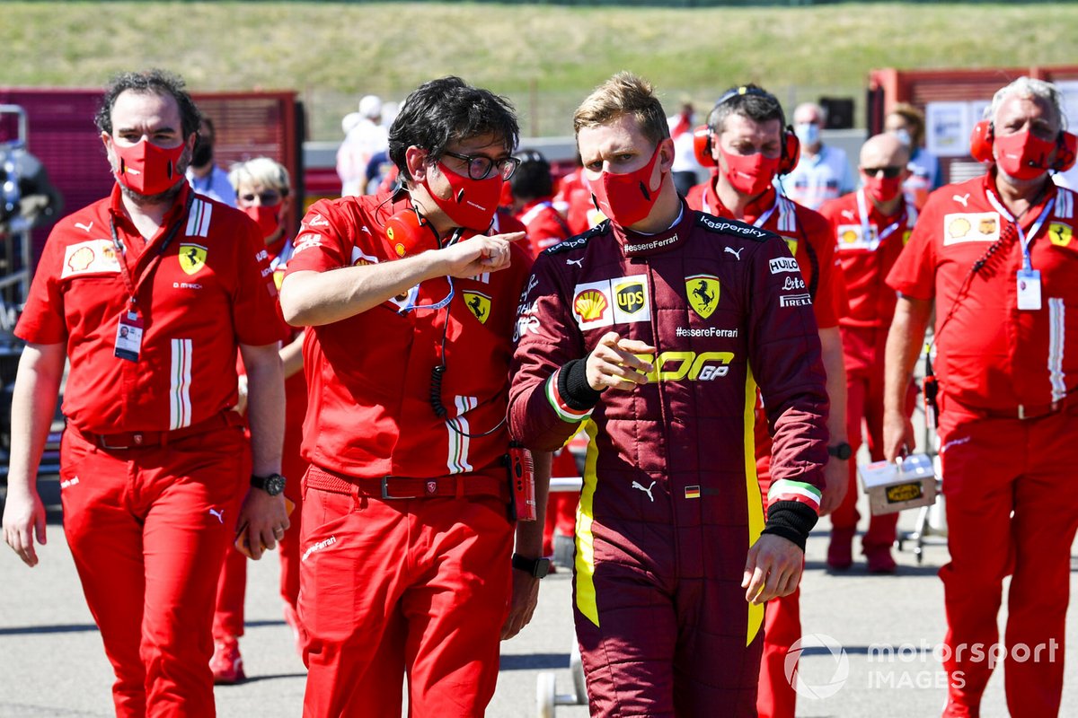 Mick Schumacher talks with Ferrari personnel