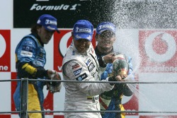 Podium: champagne for Juan Pablo Montoya, Fernando Alonso and Giancarlo Fisichella
