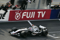 Race winner Kimi Raikkonen celebrates