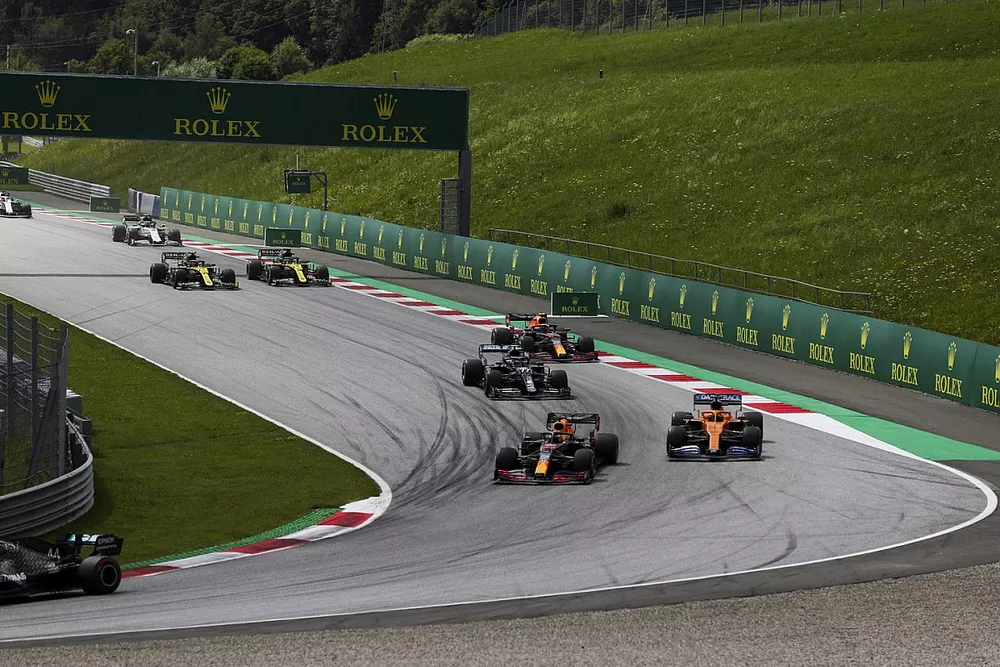 Max Verstappen, Red Bull Racing RB16, leads Carlos Sainz Jr., McLaren MCL35, Valtteri Bottas, Mercedes F1 W11 EQ Performance, Alex Albon, Red Bull Racing RB16, and the remainder of the field at the start