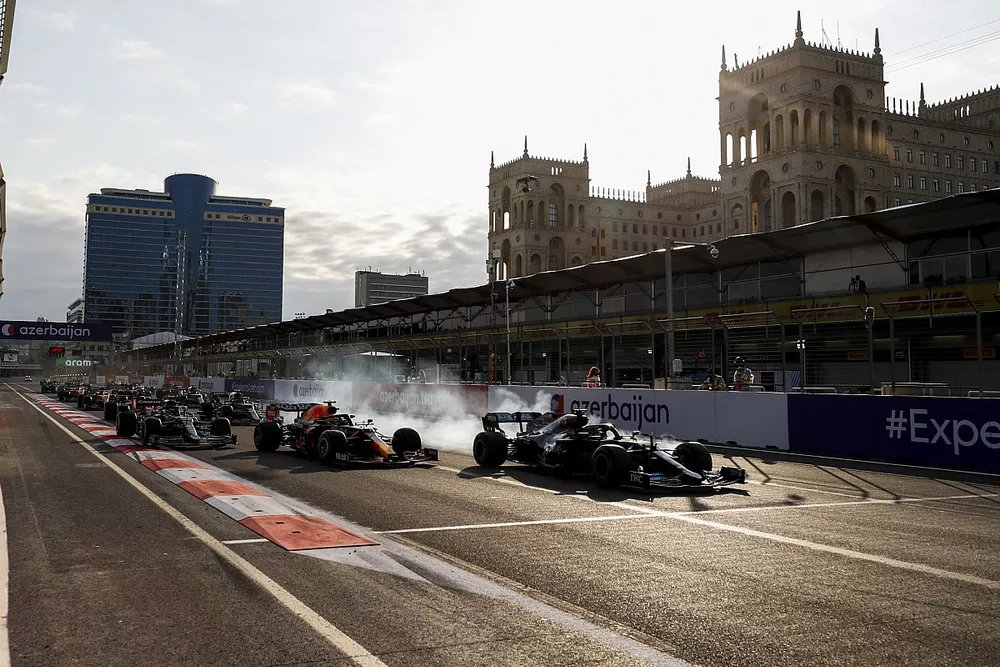Lewis Hamilton, Mercedes W12 runs wide from Sergio Perez, Red Bull Racing RB16B at the restart of the race