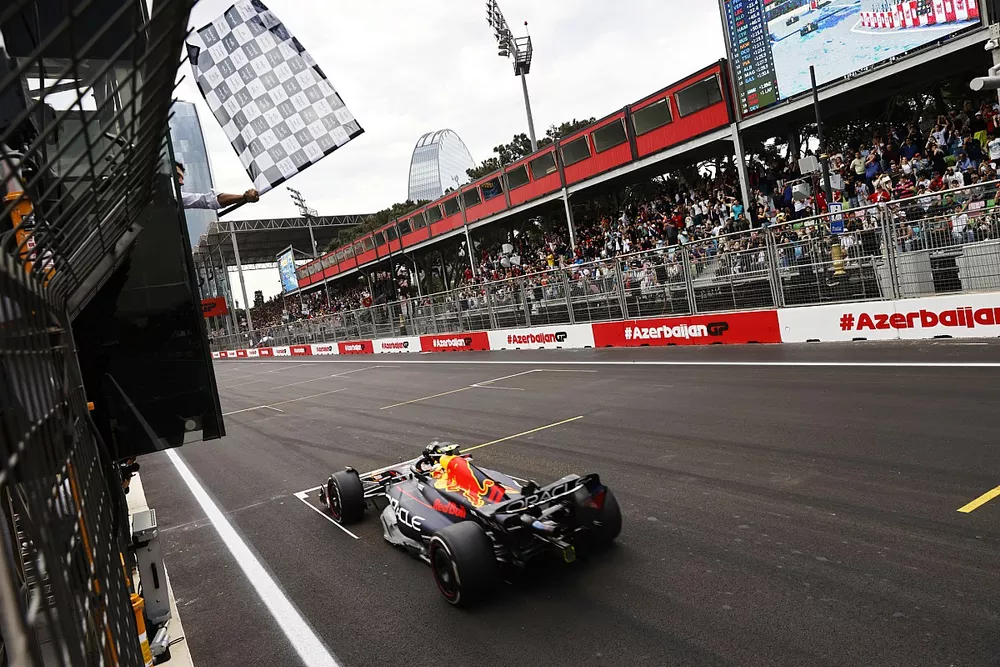 Sergio Perez, Red Bull Racing RB19, takes the chequered flag
