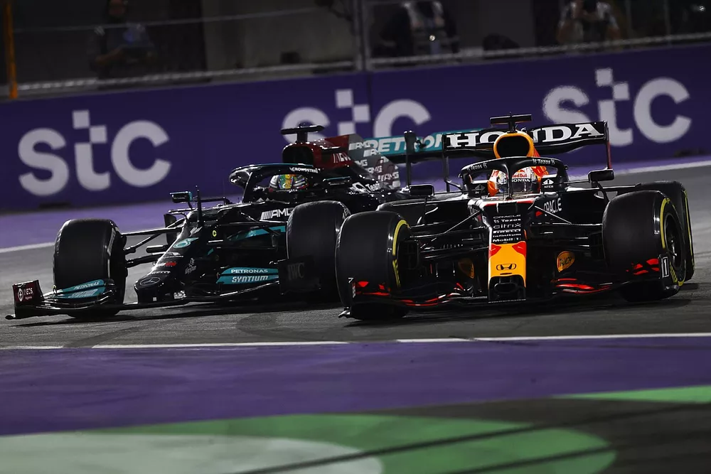 Max Verstappen, Red Bull Racing RB16B, en Lewis Hamilton, Mercedes W12, maken contact terwijl ze strijden om de leiding