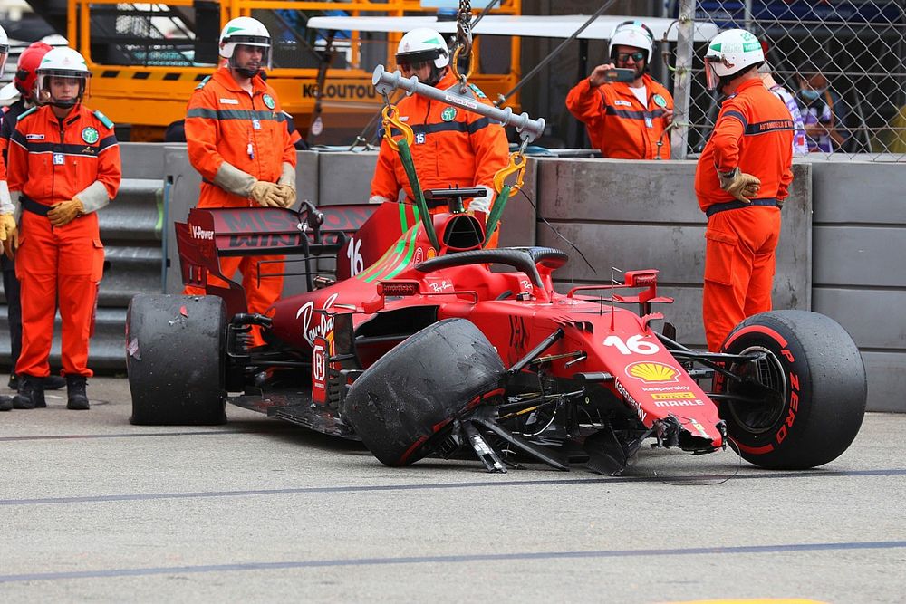 Marshals remove the car of Charles Leclerc, Ferrari SF21, from the circuit