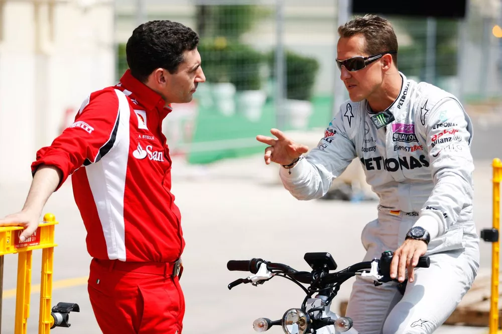 Michael Schumacher talks with Andrea Stella