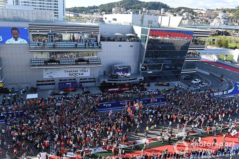 Fans flood onto the track after the race for the podium ceremony