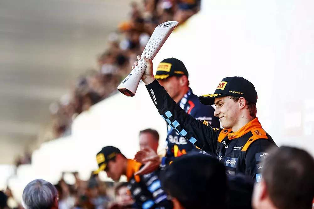 Oscar Piastri, McLaren, 3rd position, lifts his trophy on the podium
