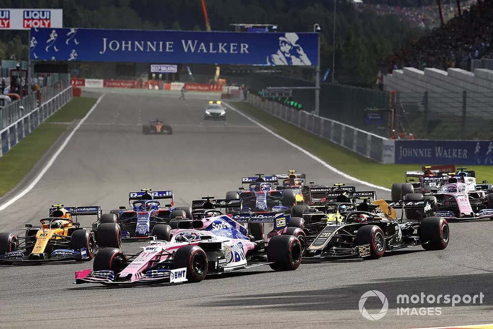 Sergio Perez, Racing Point RP19, leads Kevin Magnussen, Haas F1 Team VF-19, Lando Norris, McLaren MCL34, Romain Grosjean, Haas F1 Team VF-19, Daniel Ricciardo, Renault F1 Team R.S.19, and the remainder of the field at the start