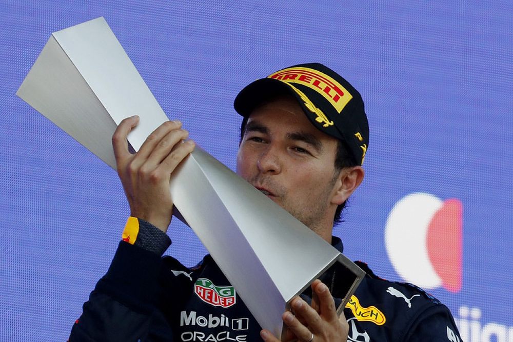 Sergio Perez, Red Bull Racing, 1st position, kisses his trophy