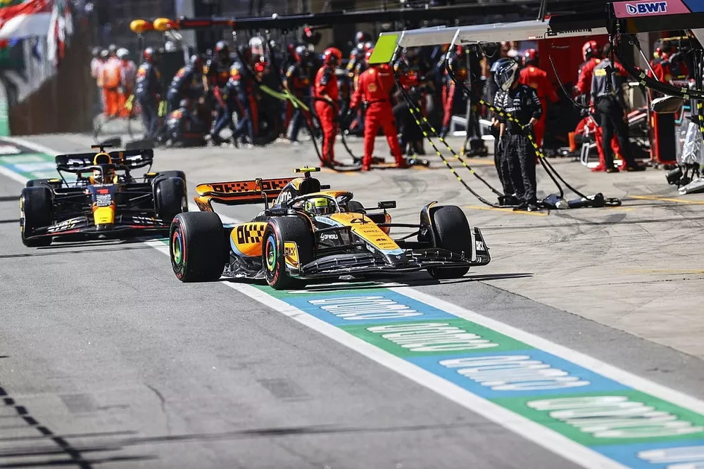 Lando Norris, McLaren MCL60, Max Verstappen, Red Bull Racing RB19, in the pit lane