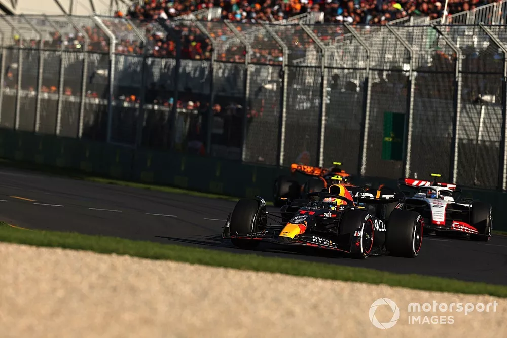Sergio Perez, Red Bull Racing RB19, leads Nico Hulkenberg, Haas VF-23, and Lando Norris, McLaren MCL60