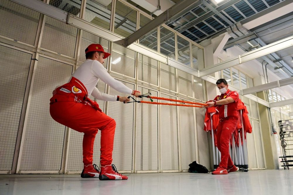 Charles Leclerc, Ferrari, stretches with his trainer