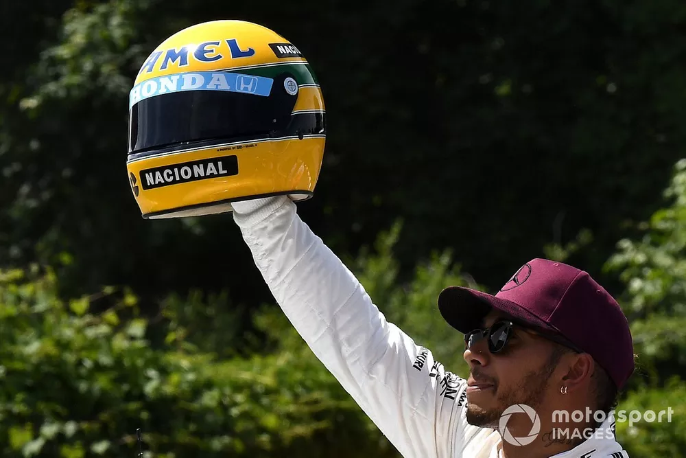 Pole sitter Lewis Hamilton, Mercedes AMG F1 celebrates in parc ferme, the helmet of Ayrton Senna