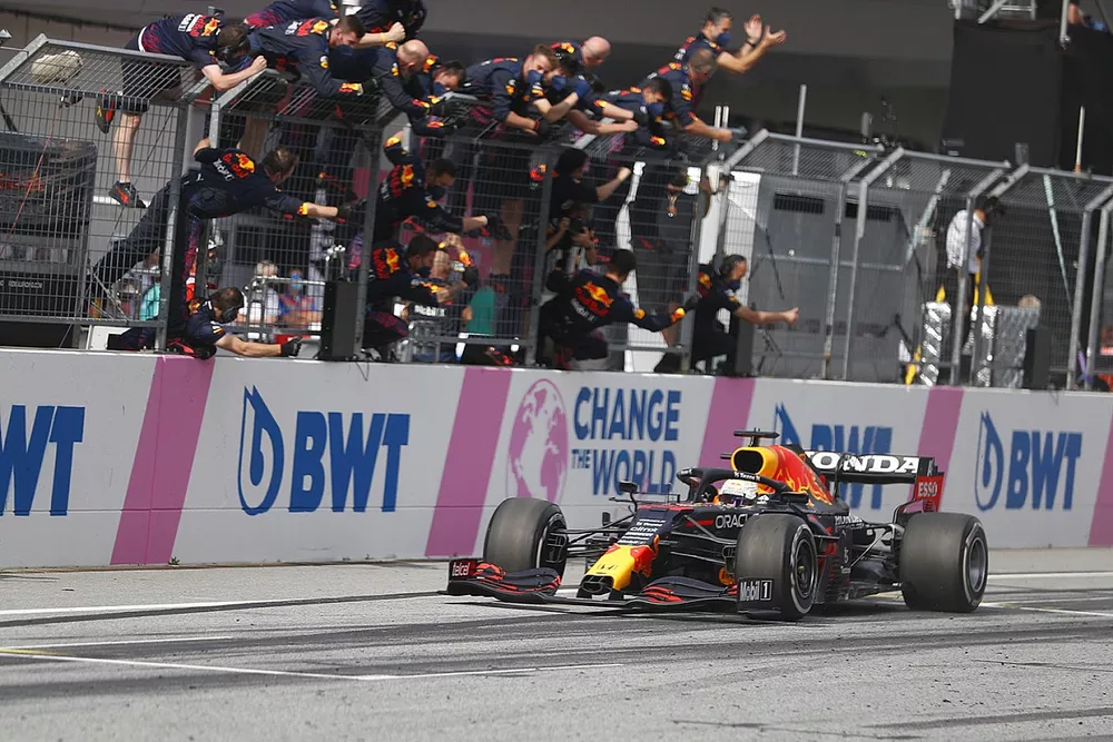Race winner Max Verstappen, Red Bull Racing RB16B passes his team as they celebrate on the pit wall