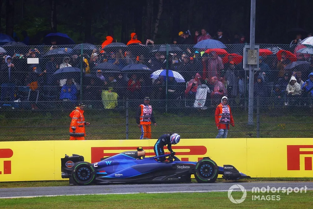 Logan Sargeant, Williams FW45, climbs out of his damaged car after crashing out in FP1