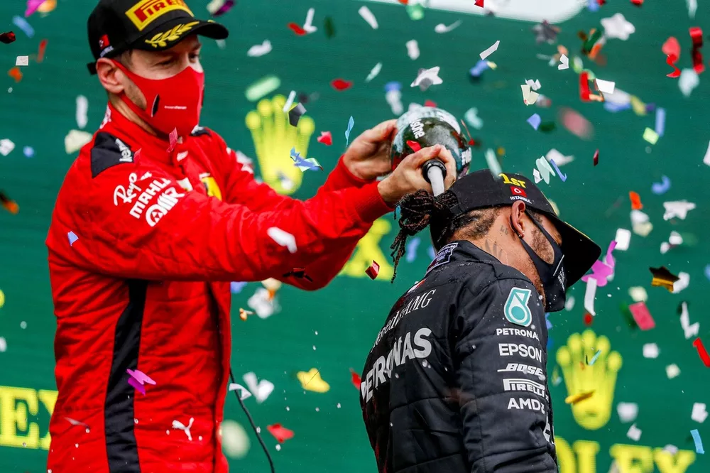 Sebastian Vettel, Ferrari, 3rd position, pours Champagne down the back of Lewis Hamilton, Mercedes-AMG F1, 1st position, on the podium