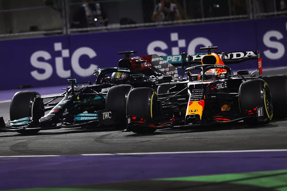 Max Verstappen, Red Bull Racing RB16B, and Lewis Hamilton, Mercedes W12, make contact as they battle for the lead