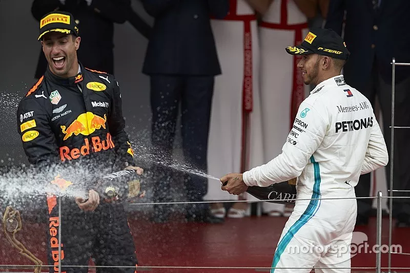 Lewis Hamilton, Mercedes AMG F1, and Race winner Daniel Ricciardo, Red Bull Racing, sprays with Champagne