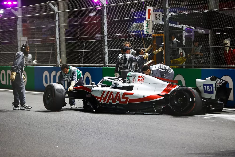 Marshals remove the damaged car of Mick Schumacher, Haas VF-22, after his crash in Q2