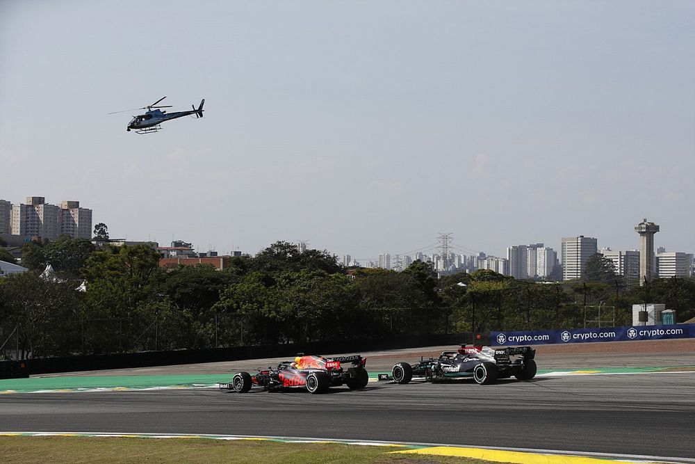 Max Verstappen, Red Bull Racing RB16B, battles with Lewis Hamilton, Mercedes W12