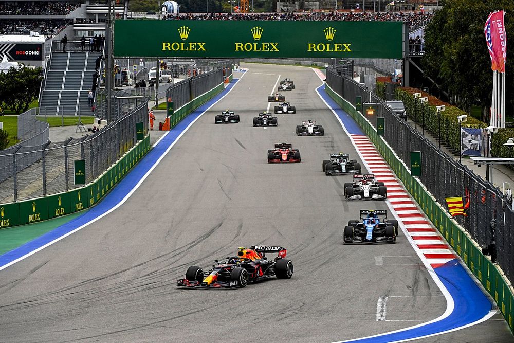 Sergio Perez, Red Bull Racing RB16B, Esteban Ocon, Alpine A521, and Kimi Raikkonen, Alfa Romeo Racing C41