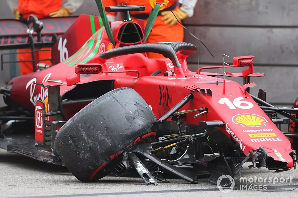 Marshals remove the car of Charles Leclerc, Ferrari SF21, from the circuit