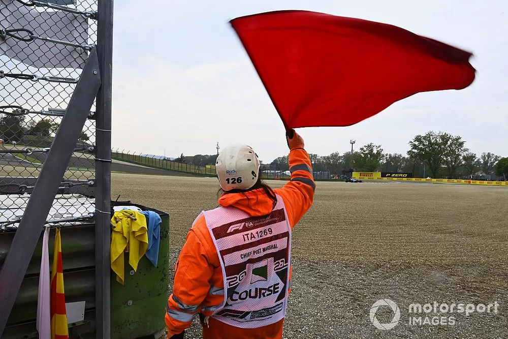 A marshal waves the red flag