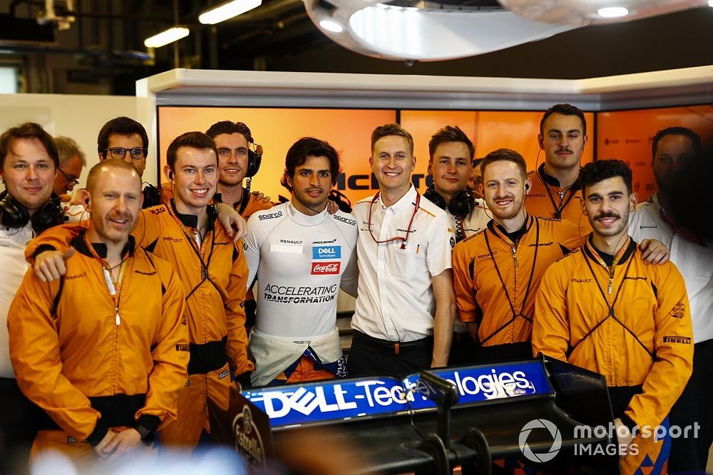 Carlos Sainz Jr., McLaren, poses with colleagues