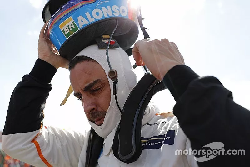 Fernando Alonso, McLaren, takes his helmet off on the grid
