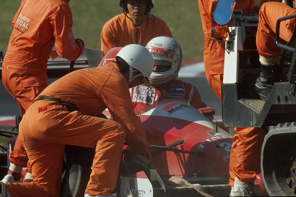 The marshals get to work removing Andrea de Cesaris car as he gets out  