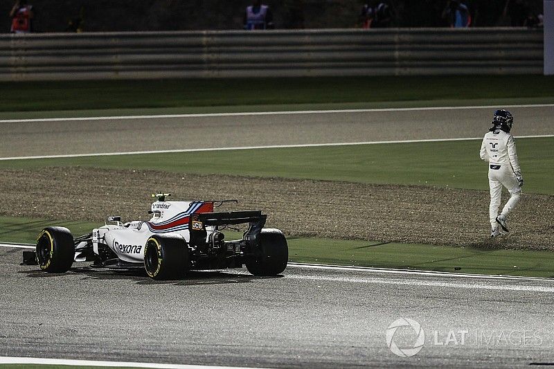 Lance Stroll, Williams FW40, climbs out of his car and walks away after a collision with Carlos Sainz Jr., Toro Rosso